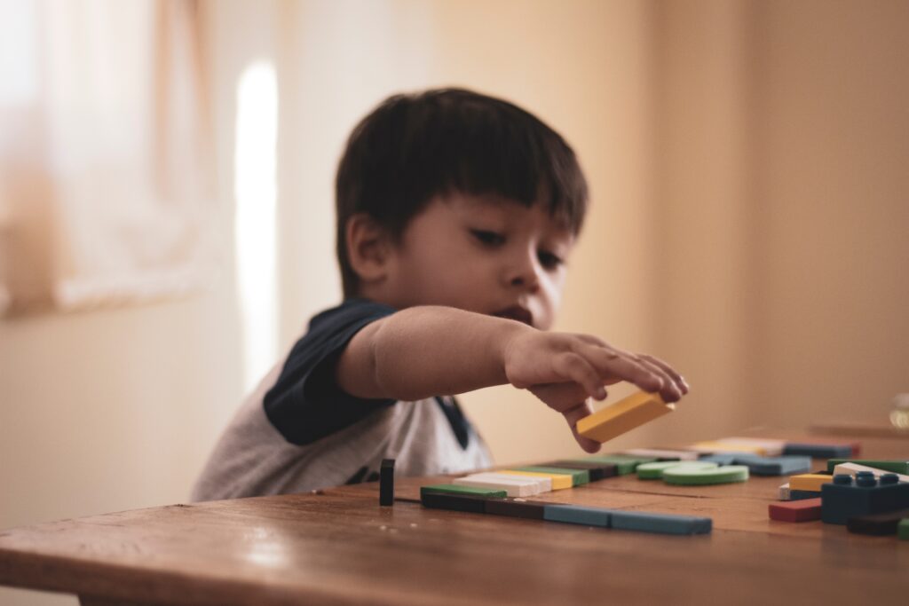 boy holding block toy 1598122